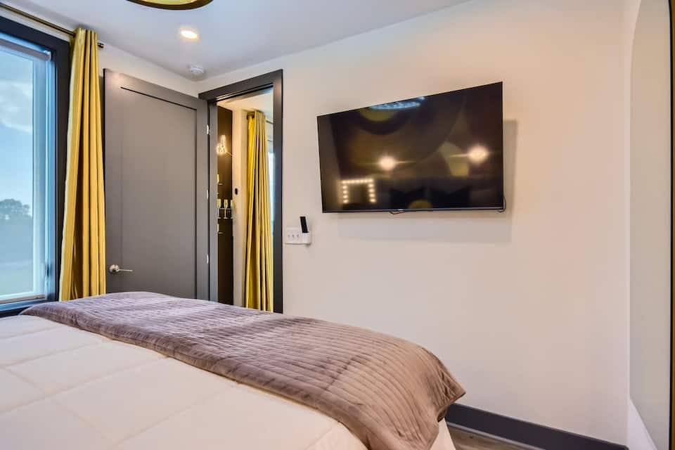 Second bedroom with queen bed and balcony access