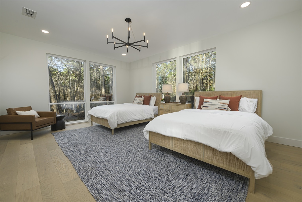 Guest Room: Bright and airy retreat with two queen beds and forest views for ultimate relaxation!