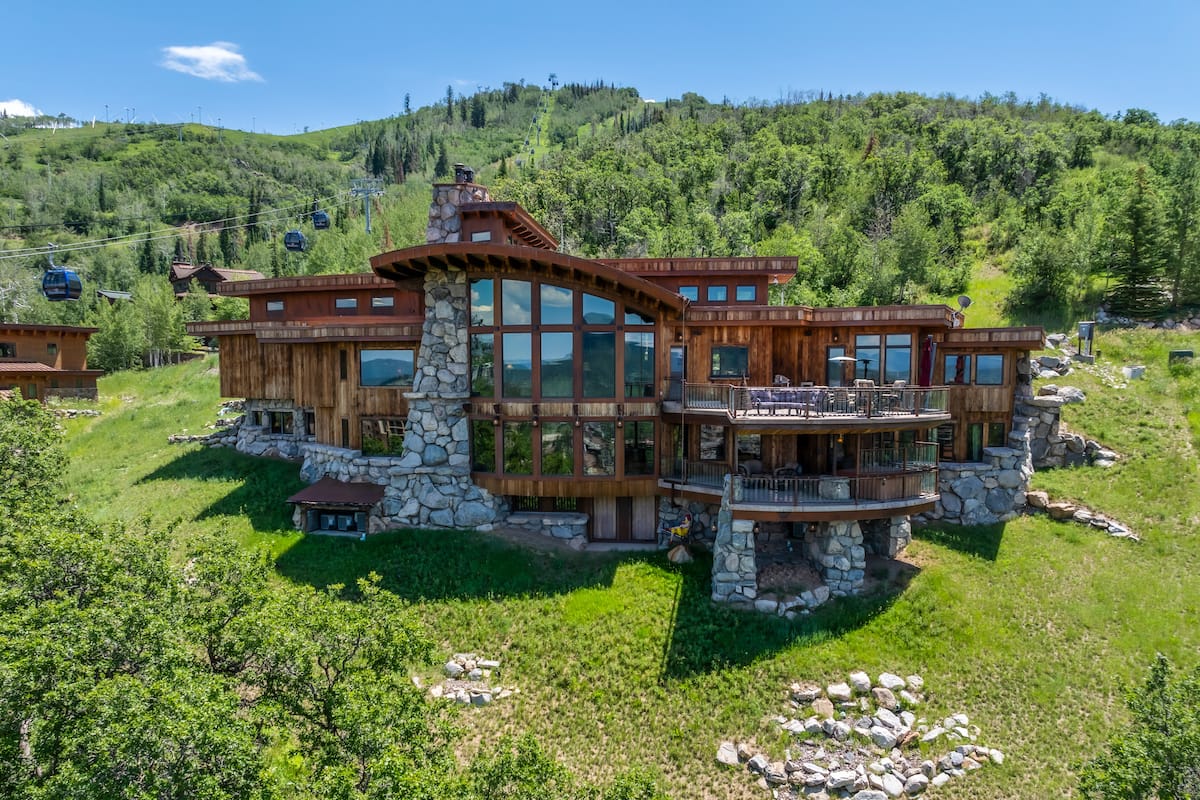 Grand living room inside Cowboy Lodge with floor-to-ceiling windows and mountain views