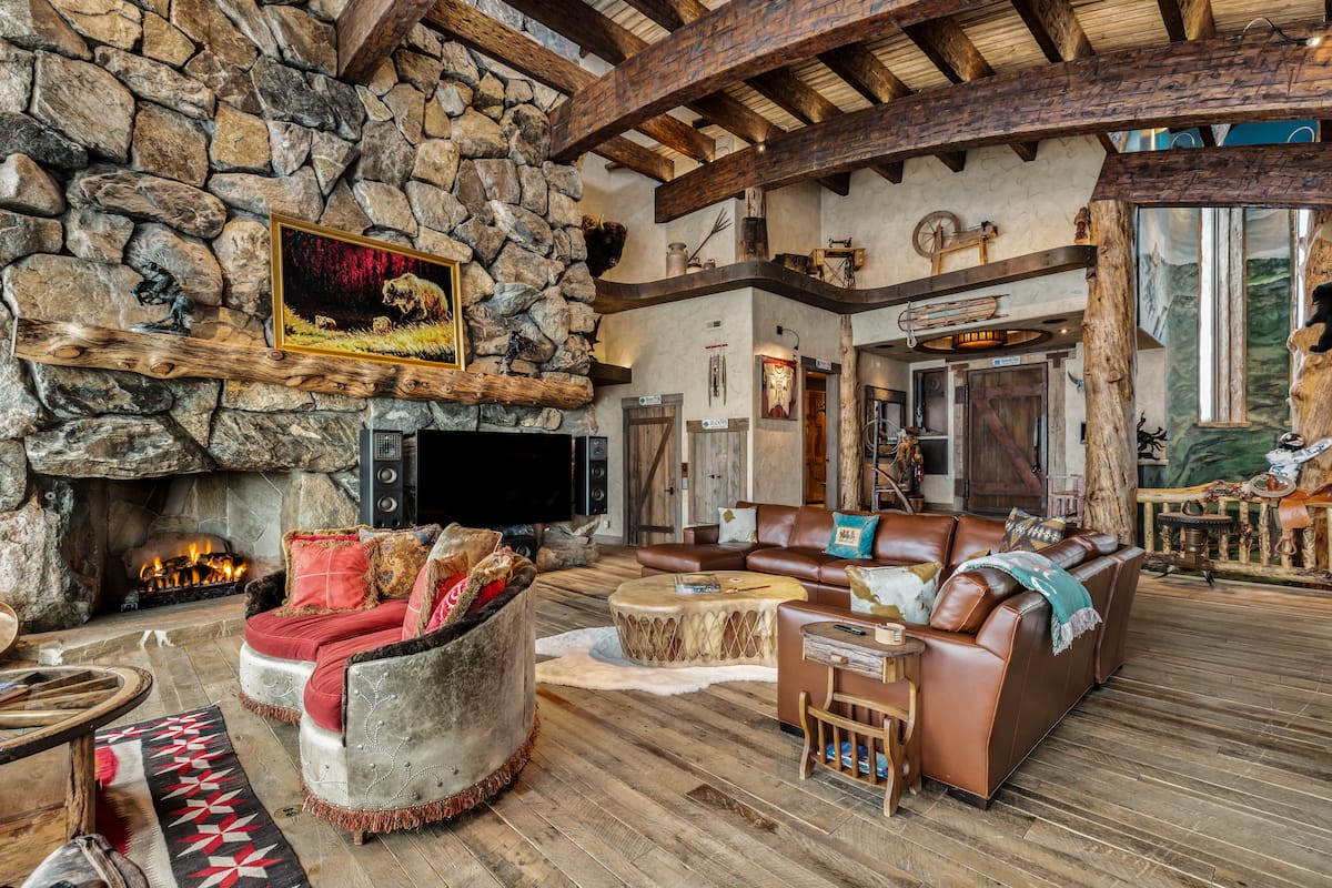 Cowboy Lodge primary bedroom suite with fireplace and luxury finishes