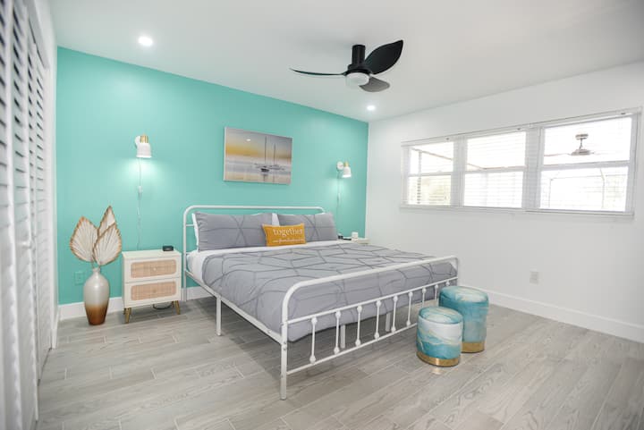 Wake up refreshed in this airy, coastal bedroom — comfy king bed, peaceful vibes, and plenty of natural light for slow, easy mornings together