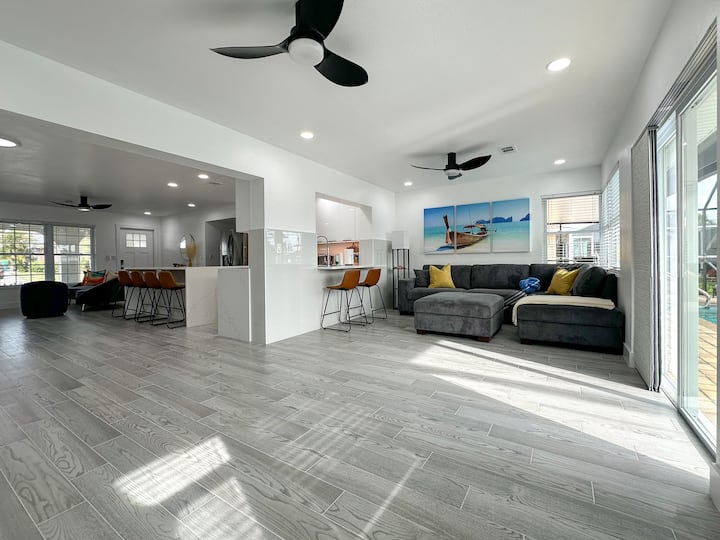 Sun-soaked lounge vibes — comfy sectional, peaceful views, and instant access to your private pool