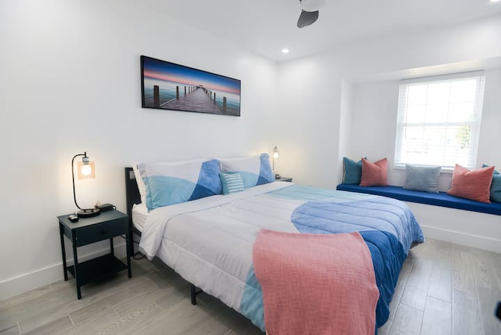 Cozy coastal comfort — a fresh, calming bedroom with a comfy bed and a sunny window seat perfect for morning coffee or a quiet moment together