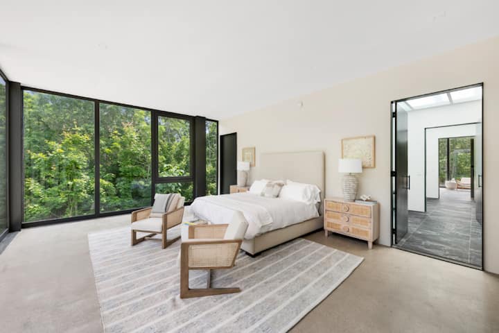 Enjoy tranquil retreats in a serene, airy bedroom, where the calm ambiance and plush bedding are ideal for restful escapes and rejuvenation.