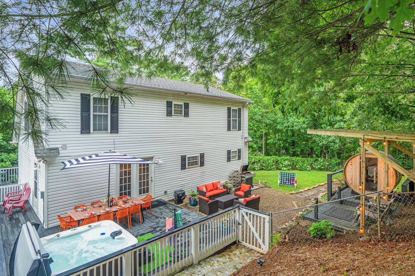 By day, you get command central out here: hot tub on one side, dining table on the other, and a giant Connect Four board