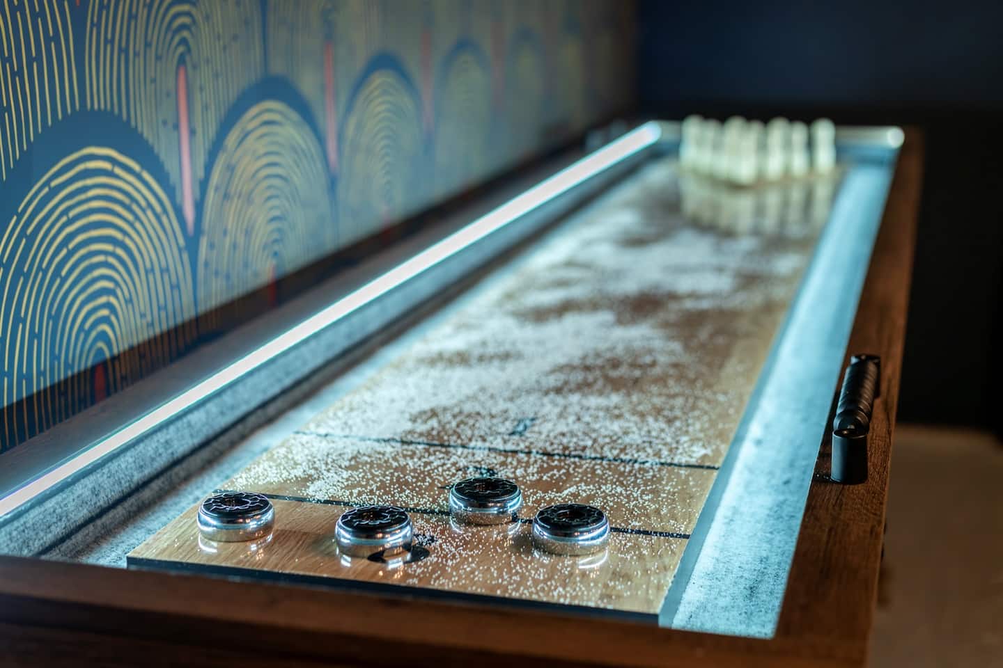 Play some shuffleboard or set up the mini bowling pins at the end