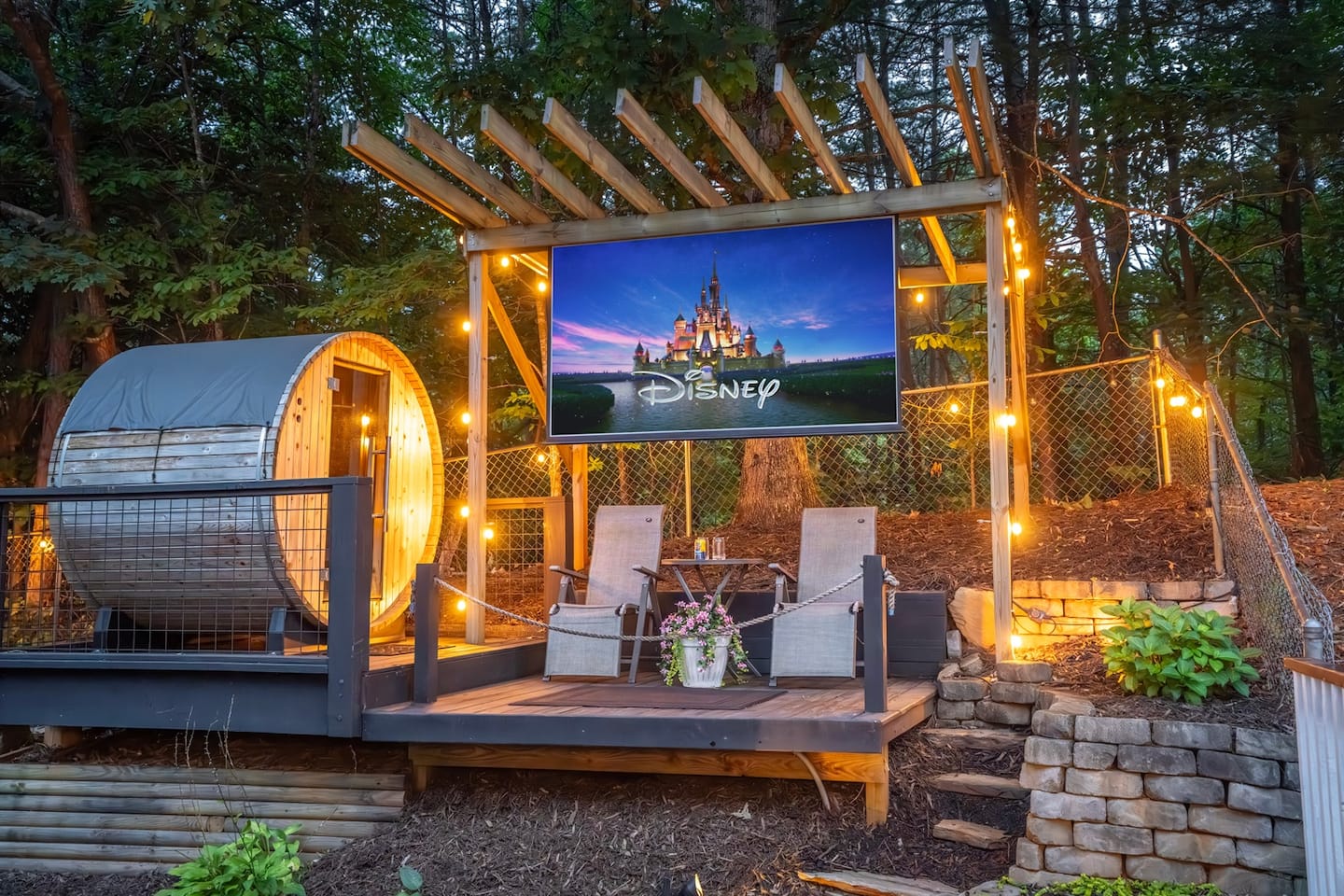 Settle into the outdoor couch, loveseat or oversized chairs below the pergola, bundle up, and let the big screen light up