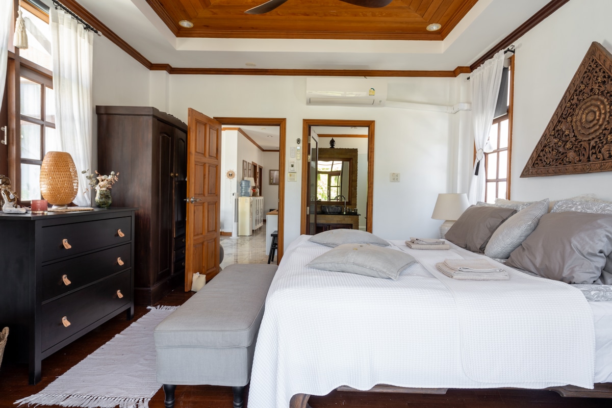 The main bedroom with en suite bathroom with bathtub and shower.