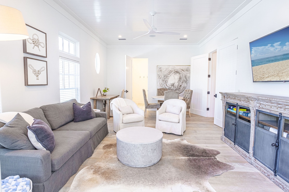 First floor living space with smart TV, Queen sleeper sofa, games, and bathroom.