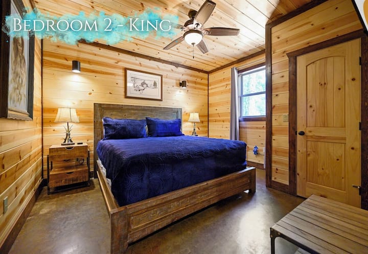 A stately king bed anchors this tranquil retreat, inviting restful slumber in a haven of natural wood.