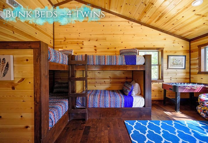 Four twin bunks, each a cozy berth, promise adventurous dreams in a snug, cabin-style chamber.