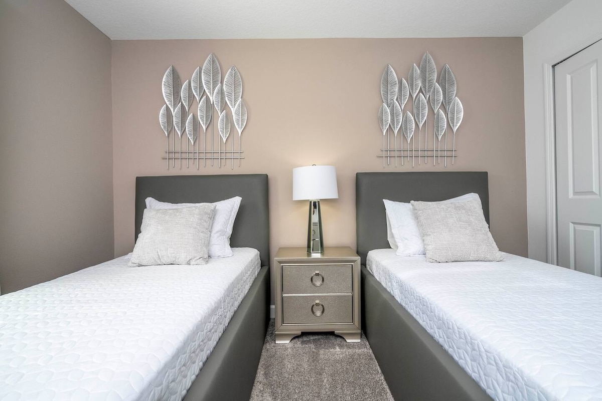 Another of our rooms adorned with delightful decor and two individual bed for every family member comfort! —a magical space designed to turn vacation time into an enchanting experience for your loved ones. 