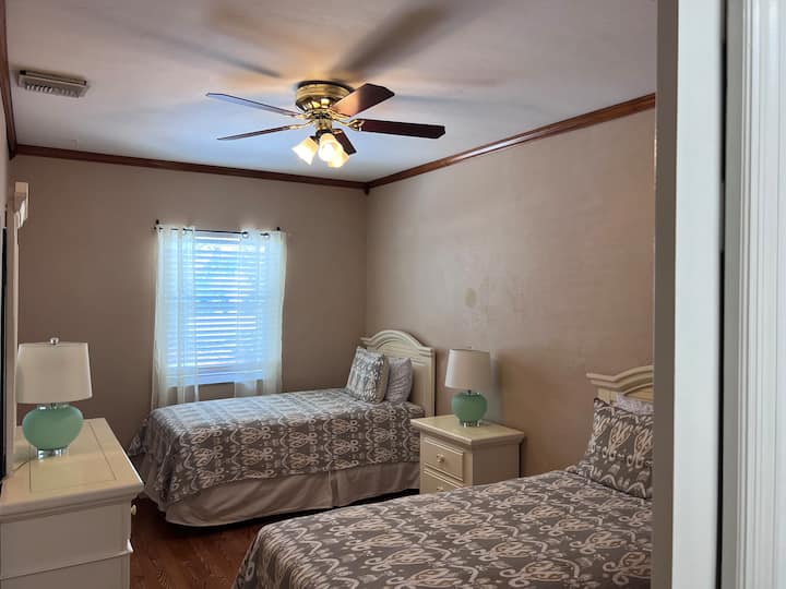 Twin Beds off of kitchen Twin bedroom is located next to second King bed off of kitchen on opposite side of home.  Spacious private, great for multiple families on vacation