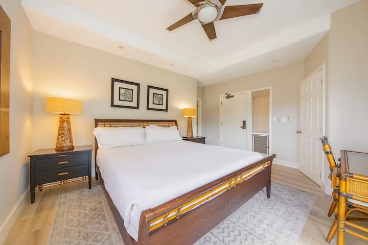 Sink into crisp linens beneath a calming ceiling fan breeze