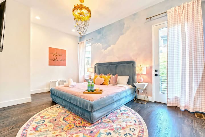 Discover a dreamy Nashville oasis! This chic bedroom boasts a plush bed and elegant decor, ideal for family reunions or bachelorette parties. Enjoy city views and luxurious comforts in this upscale vacation rental!