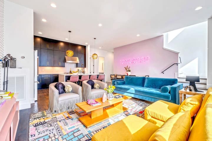 Explore a stylish oasis in Nashville! This chic vacation rental features plush seating, modern decor, and a vibrant atmosphere perfect for large groups. Ideal for bachelorette parties or family reunions, enjoy the open layout and colorful accents. E
