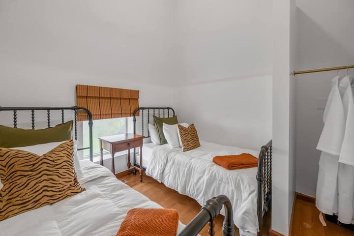 Bedroom #6 boasts a vaulted ceiling and two twin-sized beds, offering a cozy yet functional space for your stay.