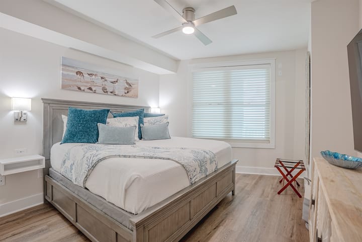 Cozy guest bedroom with a comfortable bed and simple, clean decor. A quiet spot for anyone in your group to rest and recharge.
