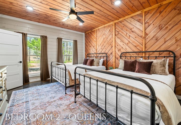 Ideal for friends or family, this bedroom with two queen-sized beds merges country charm with modern amenities