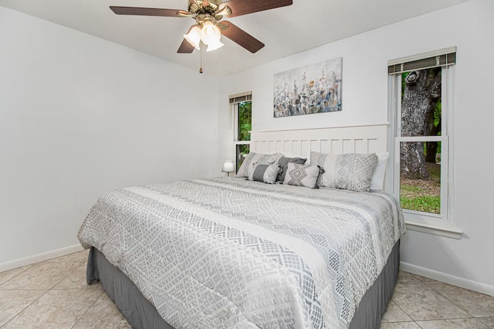 ค้นพบความสะดวกสบายในห้องนอนที่น่าอยู่นี้ด้วยเตียงขนาดคิงไซส์เครื่องนอนสีเทาเก๋ไก๋และหน้าต่างที่สวยงามซึ่งมองเห็นกิจกรรมกลางแจ้งที่เขียวชอุ่มสร้างสวรรค์ที่สมบูรณ์แบบสำหรับการพักผ่อน