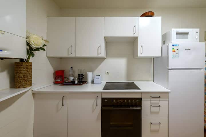 Cocina independiente con horno, vitrocerámica y espacio de encimera.