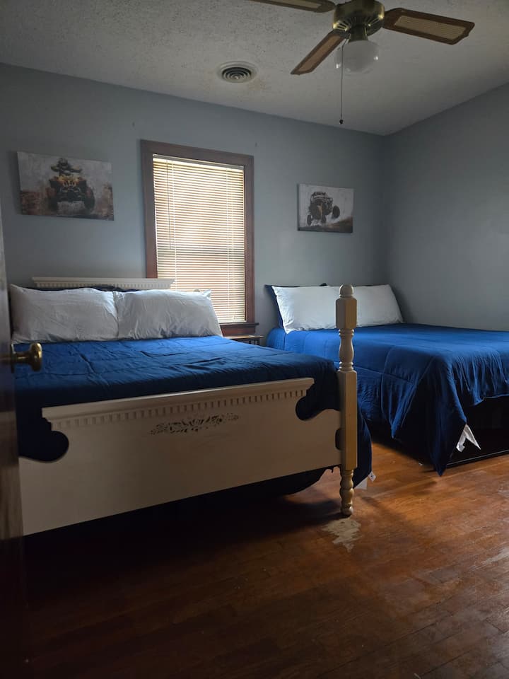 Bedroom with 2 full beds,  tv and bedside table with charging ports