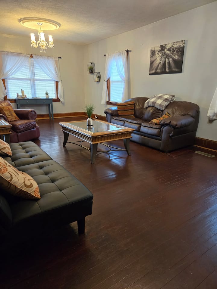 Living room area with couch,  futon sleeper couch, chair and tv