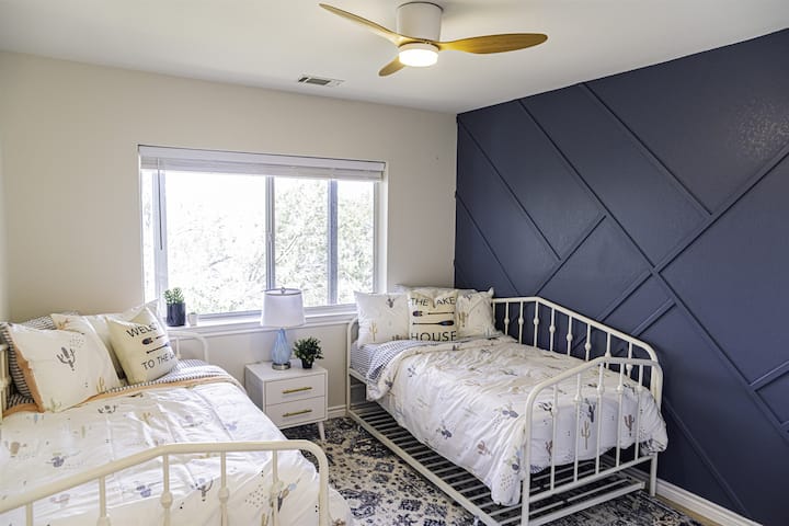 In this fourth bedroom with its lush views and trundle beds, guests are invited to unwind and embrace the tranquility of lakeside living.