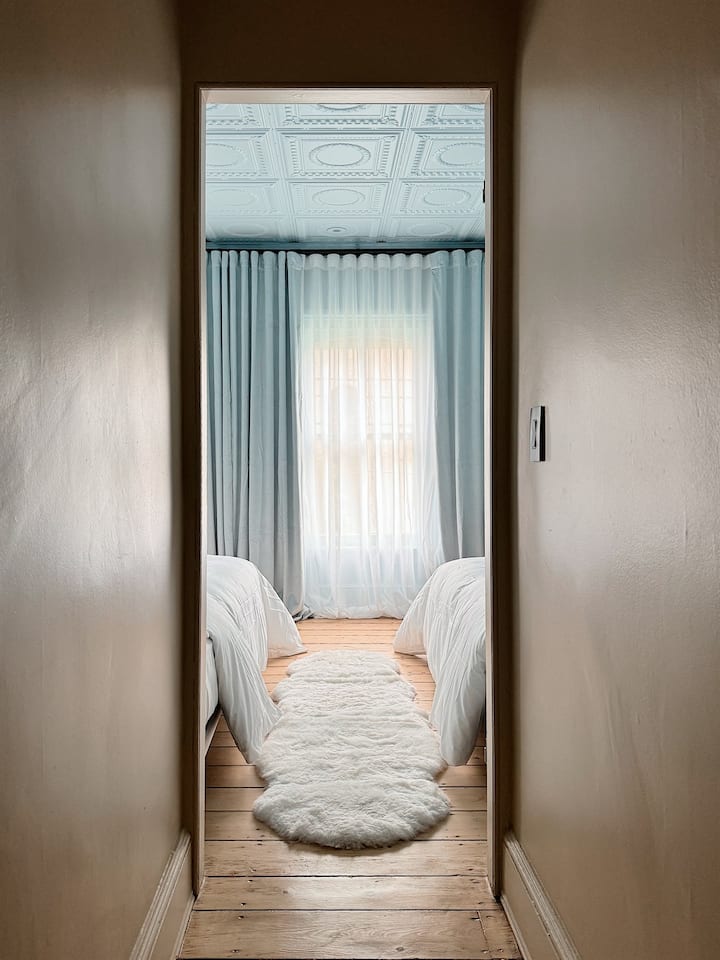The Blue Twin bedroom with two Long Twin beds and blackout shades.