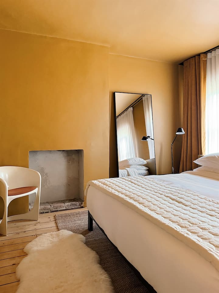 Gold King Bedroom with Tolomeo lights and blackout shades.