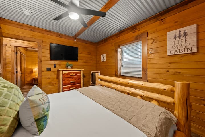 Lower Level Bedroom with Log Queen Bed, Smart TV, and White Noise Machine.
