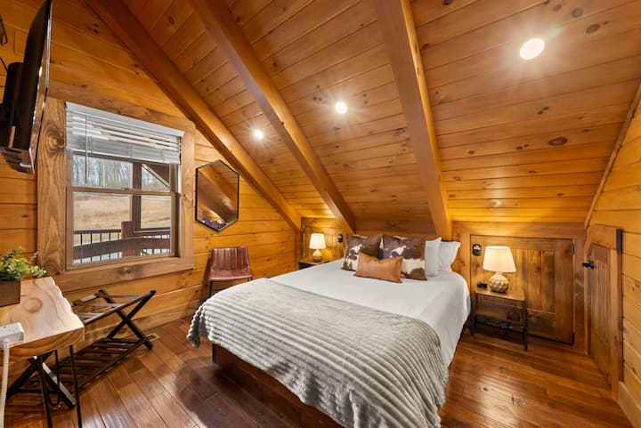 Upper Level Bedroom with Slanted Wood Ceiling, Front-Facing Sunset Views, Smart TV, and White Noise Machine.