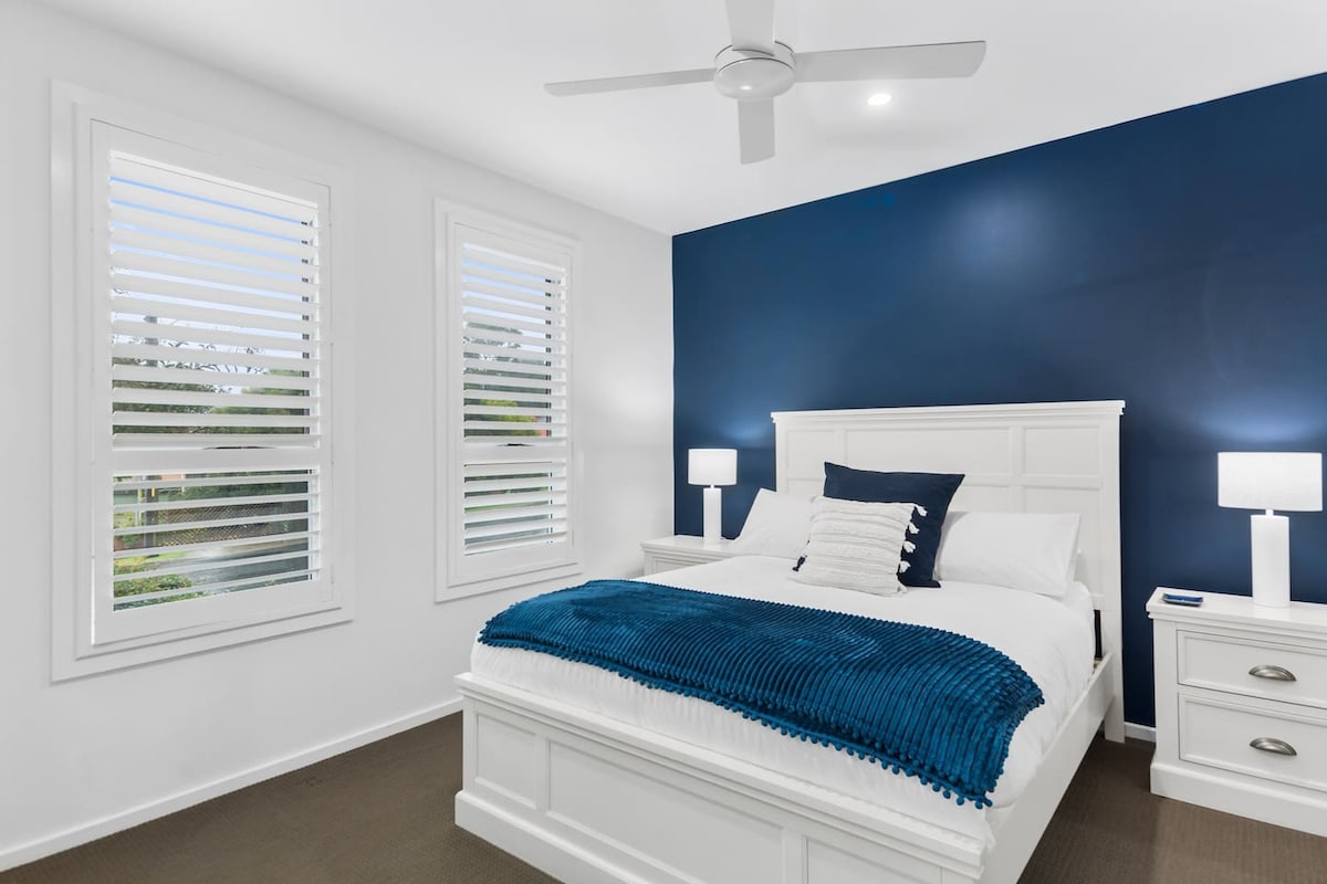 The primary bedroom highlights a plush queen-sized bed and benefits from its own ensuite bathroom.
