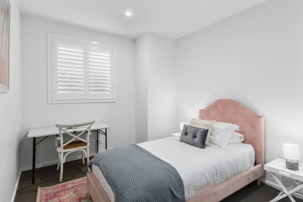 The third bedroom contains a king-single bed along with a dedicated workspace, perfect for those on a working holiday.
