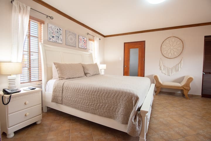 Spacious bedroom featuring a luxurious king-size bed for ultimate comfort.