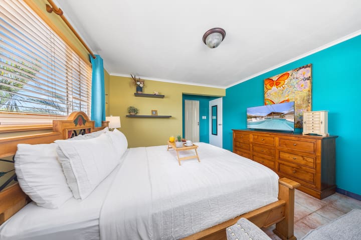 Bright and colorful Bedroom 2 with a queen-size bed and modern decor.