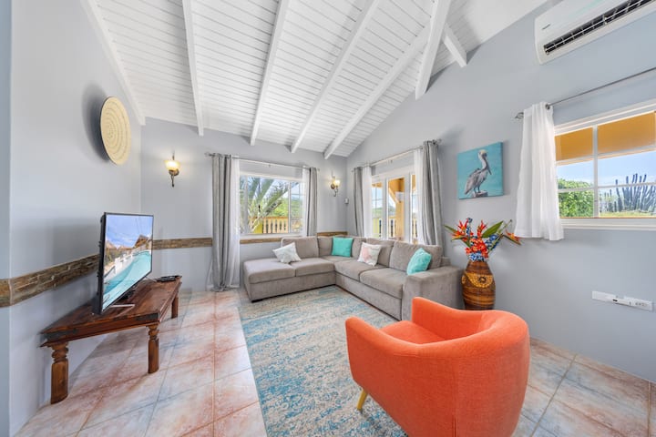 Bright and spacious living room with cozy seating and vibrant decor