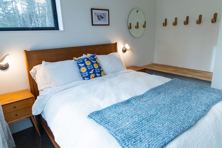 Left main bedroom, seating and storage bench and hooks.