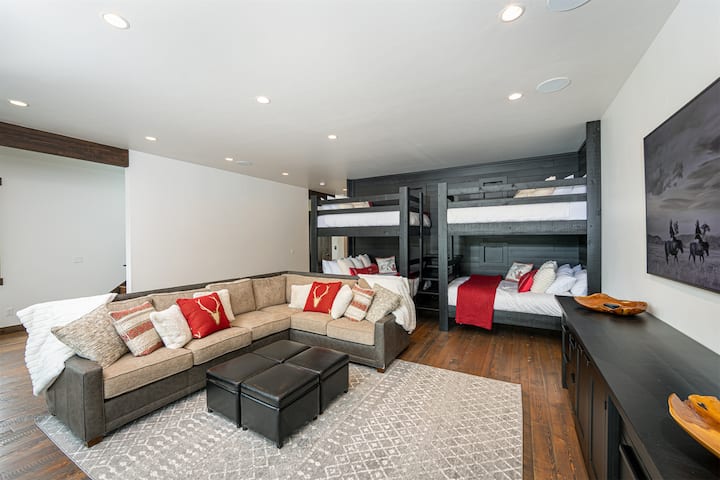 The queen bunk area has an adjoining living space with television and patio access to the home`s hot tub.