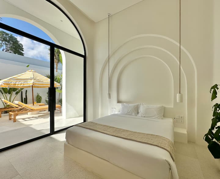 This elegant bedroom offers a comfortable king-size bed, spacious closet storage, and a sleek ensuite bathroom for a seamless, luxurious stay.
