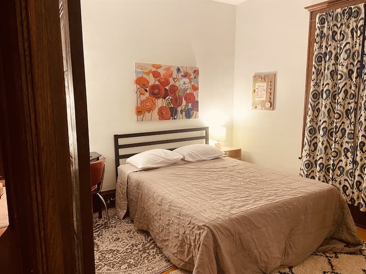 Queen bed with private desk and workspace.