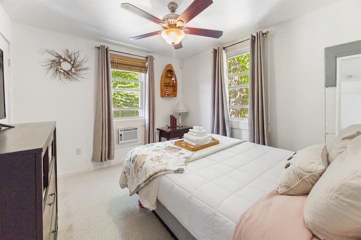 Queen bed with amazing windows and towel decoration
