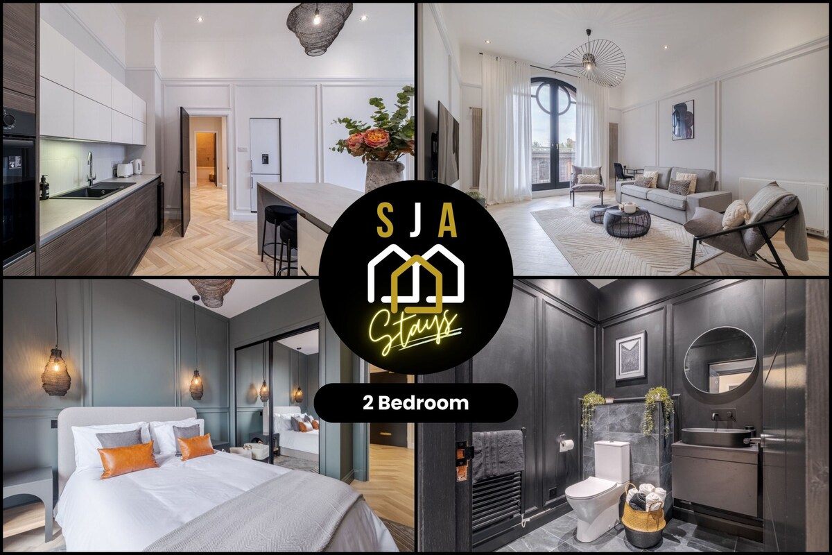 A modern apartment featuring an open plan kitchen and dining area with sleek cabinetry, complemented by a spacious lounge with large windows. Stylish furnishings include a comfortable sofa and decorative lighting, while two bedrooms showcase tasteful decor with ample storage and a contemporary bathroom.