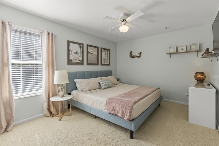 Pink room with writing desk and king bed