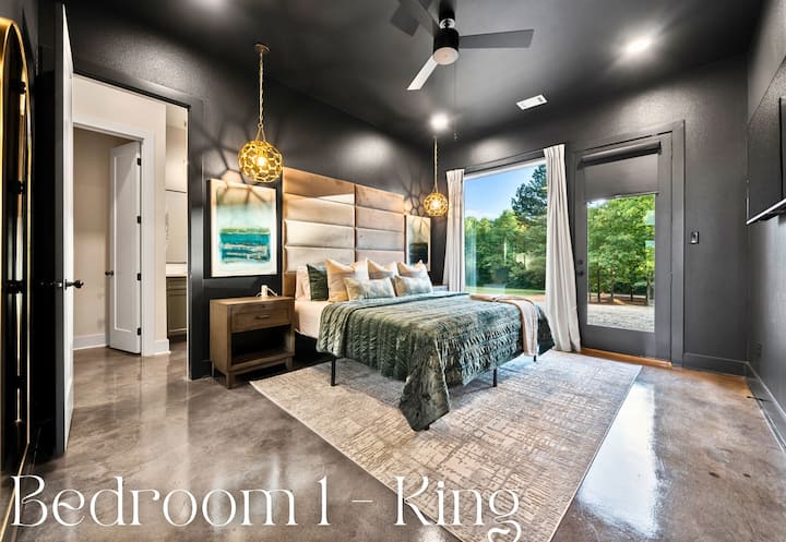 The spacious king-sized bed, featuring an elegant, padded headboard, is the centerpiece of this luxurious bedroom.