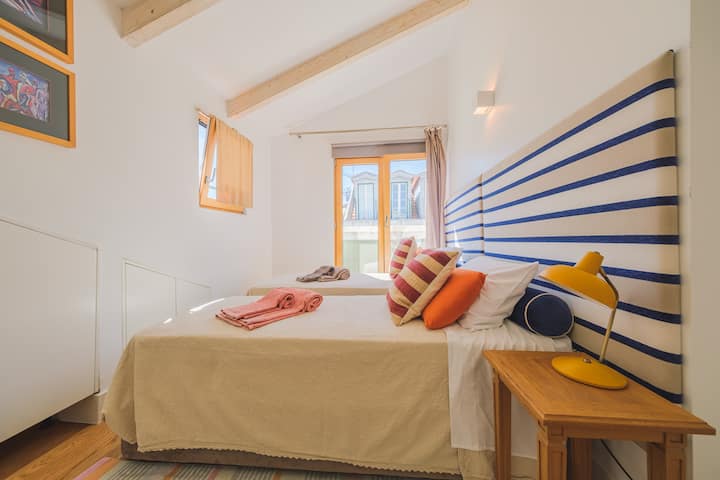 Room with two single beds and air conditioning