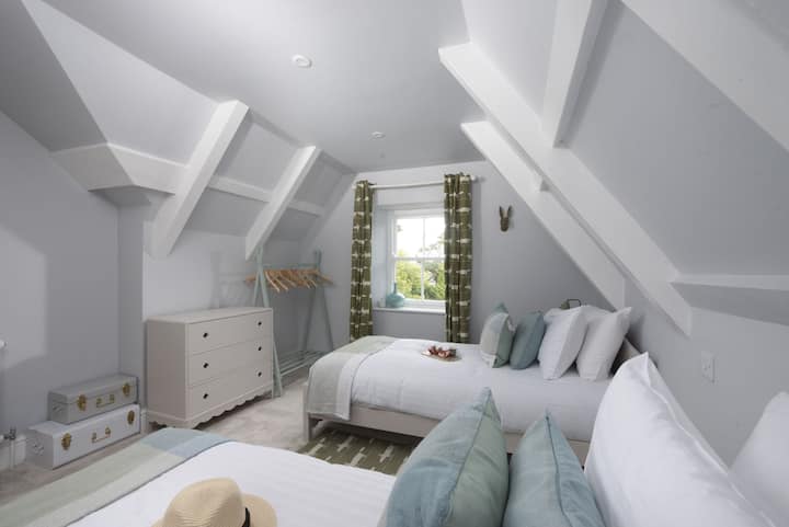 Twin beds with cushions and a chest of drawers - The Elms