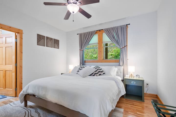 The primary bedroom is a retreat at the end of the day. King bed, clothing storage in a walk-in closet, a 43" Smart TV, and bedside tables complete with reading lamps.