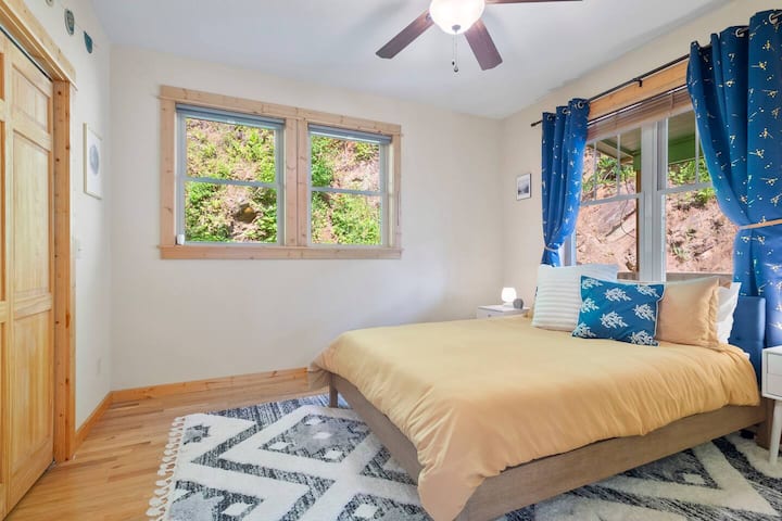 The downstairs queen bedroom is cozy and peaceful and has room-darkening shades and curtains for privacy and comfort.