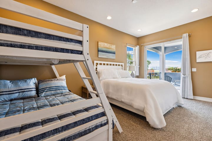 Quarto de hóspedes com beliches de casal e uma cama queen adicional